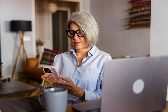 Woman using smartphone indoors