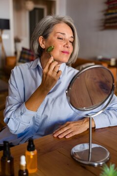 Woman using jade roller