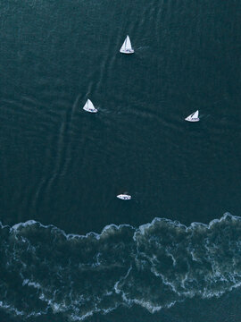 Sailboats on ocean near coastline