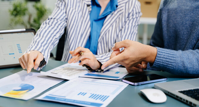 Businessman and team analyzing financial statement Finance task. with smart phone and laptop and  tablet. Wealth management concept