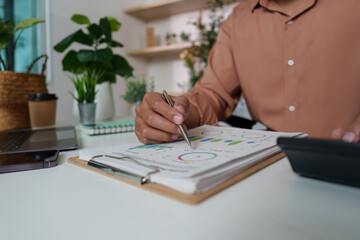 Financial Review. Individual analyzing data charts in a stylish workspace.