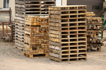 Stacked pallets and wood at a manufacturing facility