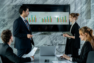 Business meeting in progress with caucasian male presenter sharing report, multiracial team members...