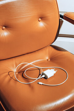 Charger on brown padded leather