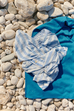 Still life detail of personal items of clothing in the beach