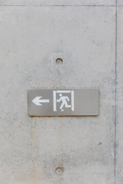 Emergency exit sign on concrete wall