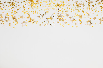 New Year, Christmas or birthday festive blank background on white top view. Celebration composition with golden confetti stars and serpentine party streamers.