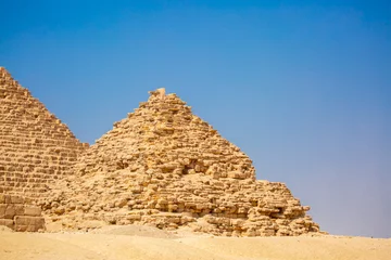 Papier peint photo Egypte The Giza Pyramids in Cairo, Egypt, panoramic view. General view of the pyramids from the Giza plateau. Three pyramids, known as the Queen's Pyramids, are on the front.  © Vera
