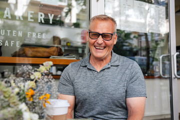 Smiling senior enjoying coffee outdoors
