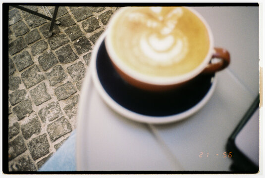 Enjoying Coffee at a Cozy Outdoor Cafe During the Afternoon