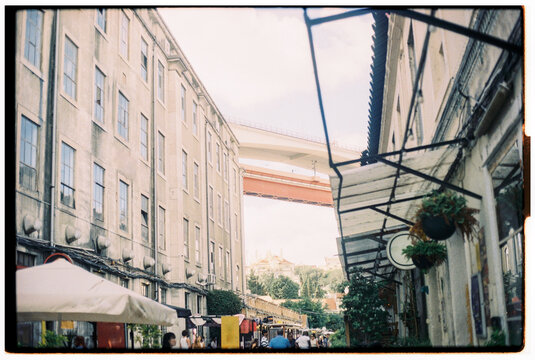 Vibrant Street Scene in a Lively City Under a Bridge