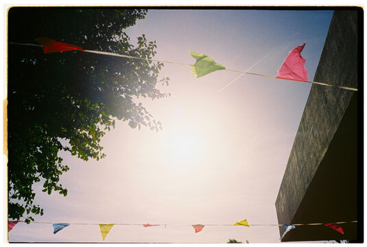 Colorful flags hanging under bright sun
