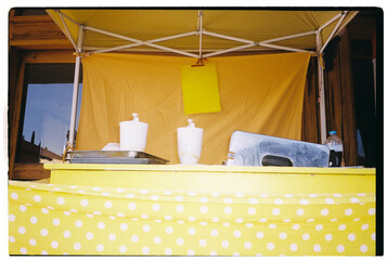 Yellow food stall with dispensers 