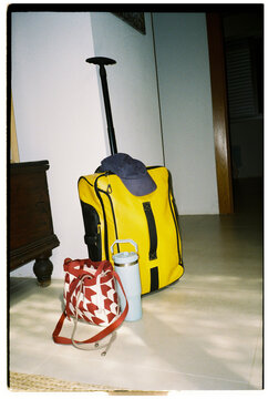Travel bags and bottle ready by the door