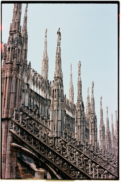 view of Milan Cathedral gothic spires against the clear sky, 35mm film