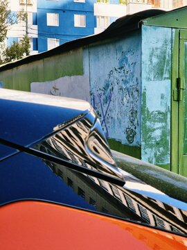 Urban reflection on a colorful building surface
