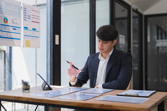 Young businessman analyzing financial data during office meeting
