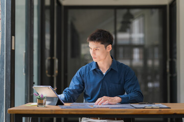Business professional reviewing documents on digital tablet