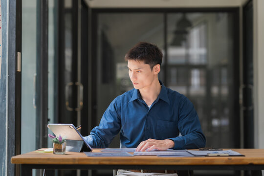 Business professional reviewing documents on digital tablet