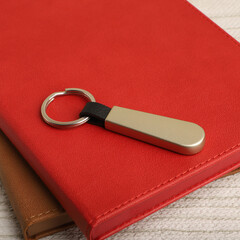 Elegant Keychain on Colorful Hardcover Agenda, concept shot, desktop top view shot.