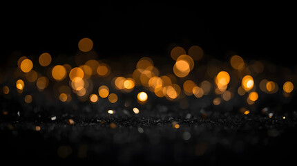 Defocused gold bokeh light with blurred effect on black abstract background
