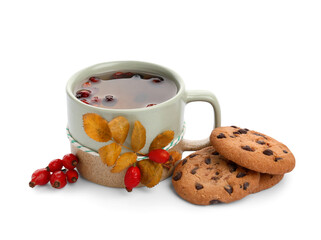 Mug with rose hip tea and cookies isolated on white background, closeup