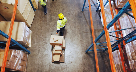 Logistics, man or walking with trolley in warehouse to transport boxes, supply chain or shipping....