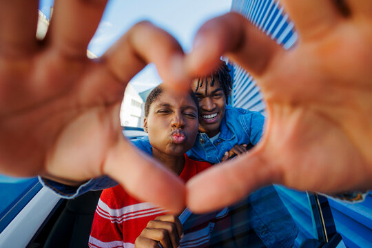 Couple making heart hands sharing love