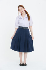 tudio portrait of asian cheerful happy young teenage girl woman wearing eyeglasses white blouse navy pleated skirt posing on white background, student high school uniform, education lifestyle concept
