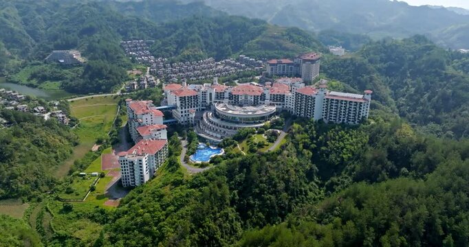 Establishing drone shot circling an enourmous hotel complex, summer in China