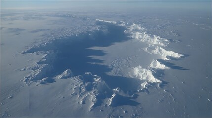 surface with deep blue crevices and sparkling snow under bright sunlight
