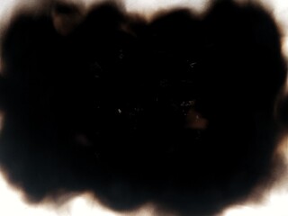 Burned paper with black marks isolated on white background. Paper surface damaged by fire with dark burn stains.
