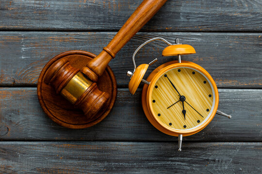 Alarm clock judges gavel, top view. Deadline and time management concept