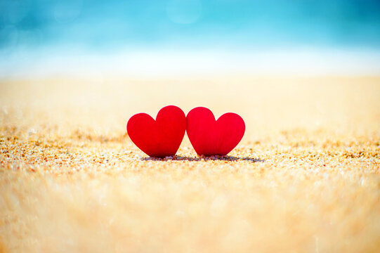 romantic symbol of two hearts on the beach
