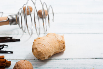 ginger root and dessert ingredients on white wooden