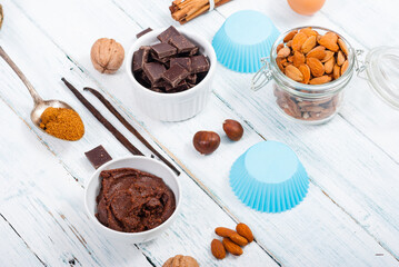 muffin baking ingredients on white wooden table