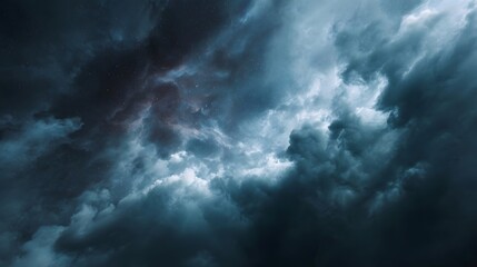 Obraz premium Dramatic dark clouds swirl in a stormy sky with ethereal light piercing through evoking a sense of cosmic wonder