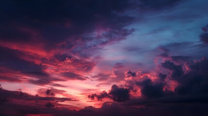 Naklejka premium Dramatic sunset sky ablaze with vibrant crimson purple and blue clouds reflecting cosmic dust and dark voids in a serene twilight