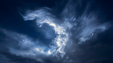 Dramatic high altitude cirrus clouds against a deep blue twilight atmosphere