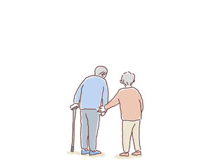 杖をついて歩く高齢男性に寄り添う高齢女性の後ろ姿