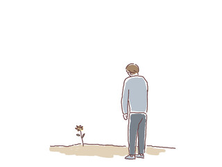 一輪の花を見つめる男性の後ろ姿