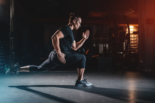 Male bodybuilder training with trx for strength in gym, Man performing suspension exercise using special equipment during workout - Powered by Adobe