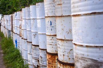 Unused barrels neatly arranged to form a yard boundary wall. Reusing used items into something more useful.