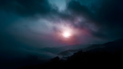 Majestic mountain landscape at dusk with dramatic clouds and fog