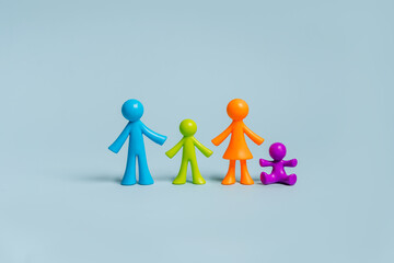 Multicolored figures of little men family on isolated blue background