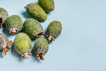 Feijoas lie on a blue isolated background