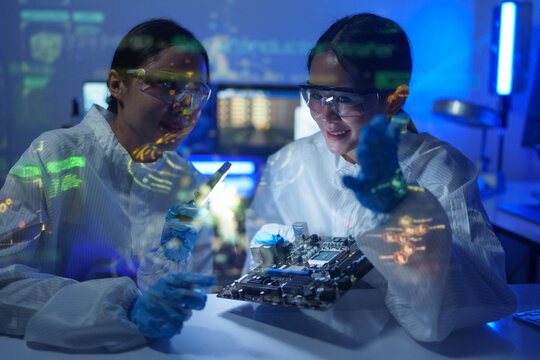 Engineers work in semiconductor or microchip labs in the electronics industry. Electronic engineers in computer technology, CPU maintenance, hardware, motherboard component upgrades.