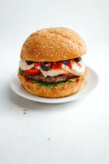 Hearty gourmet burger with fresh toppings on a sesame seed bun