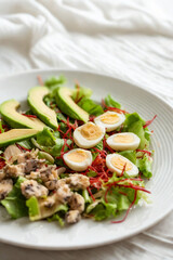 Healthy avocado and egg salad with fresh greens
