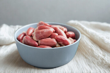 Raw chicken gizzards in a blue bowl ready for cooking